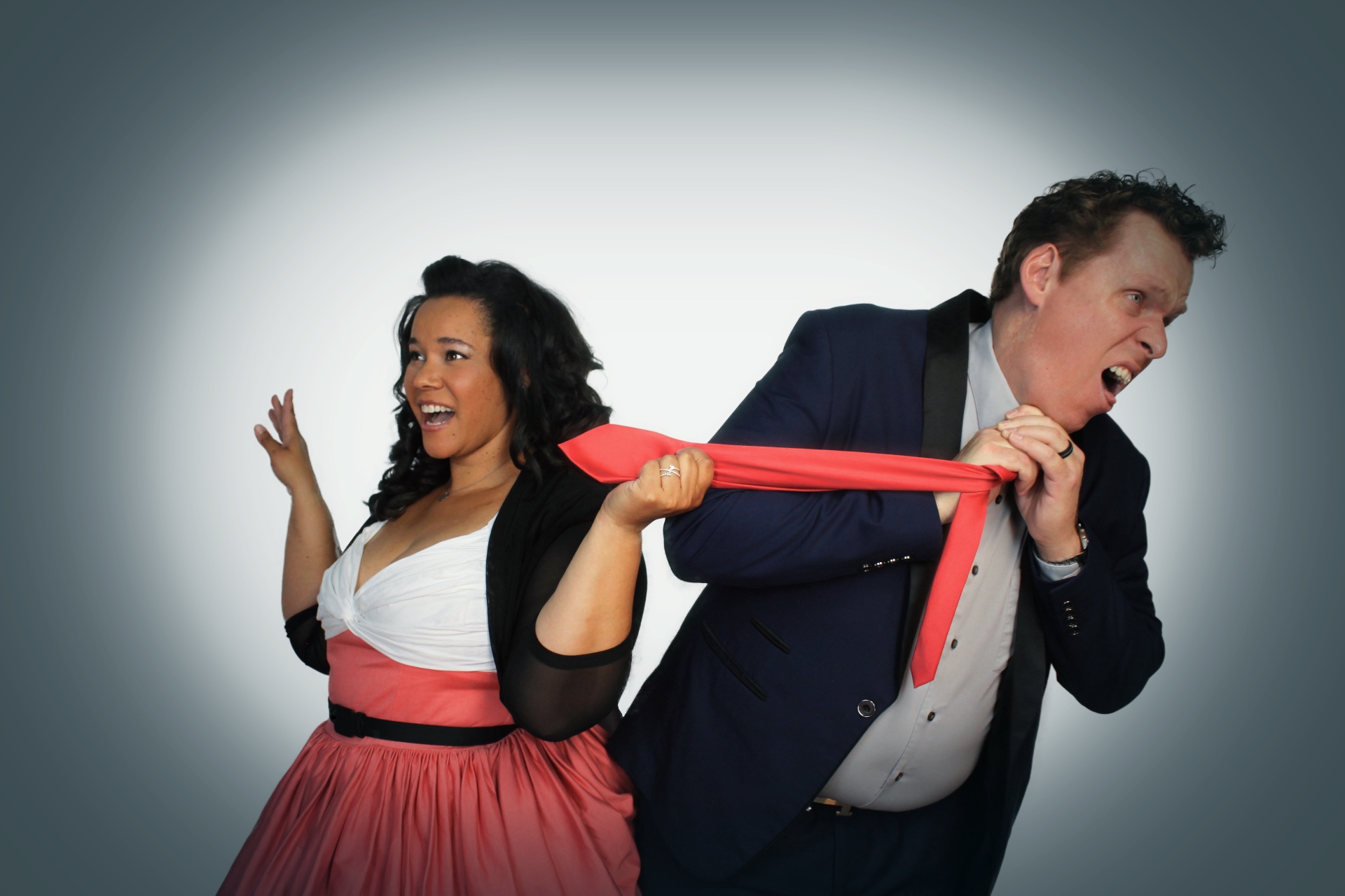 Veronica playfully pulling Dave by his pink tie